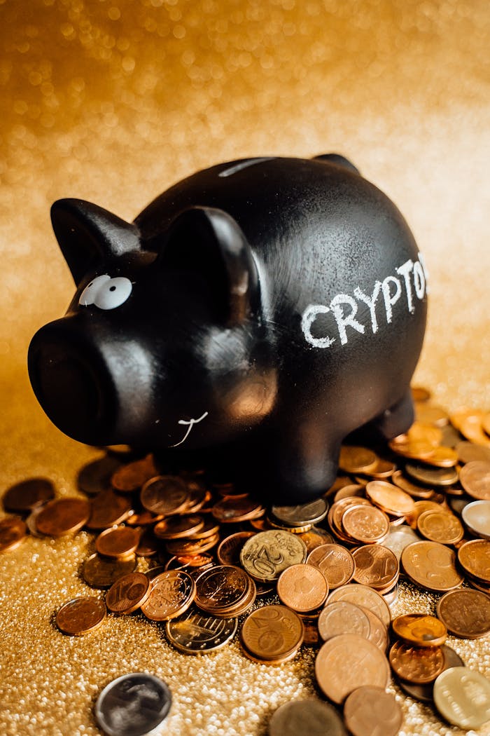 A black piggy bank labeled 'CRYPTO' surrounded by various coins on a gold background.